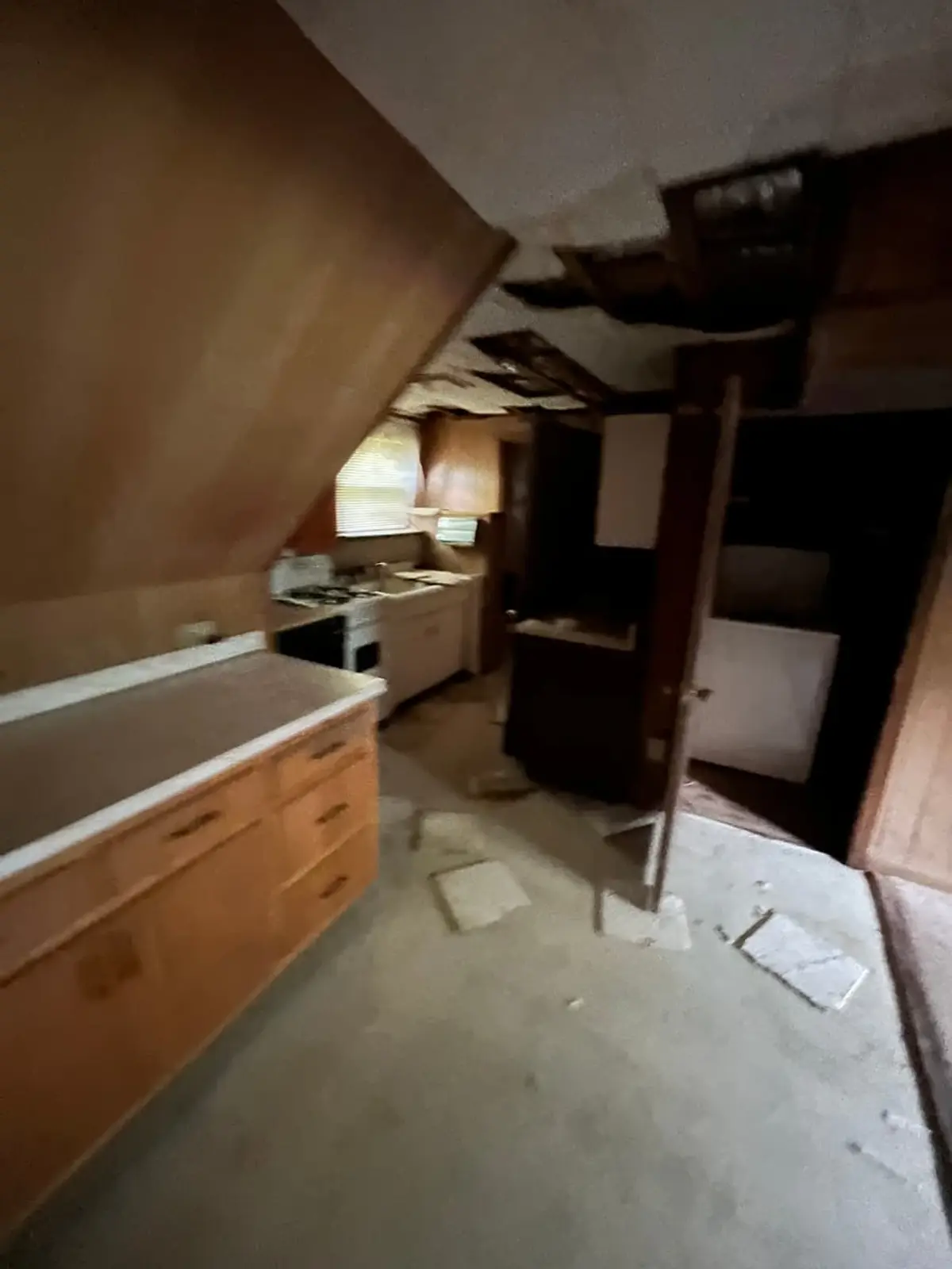 Selling a house for a job relocation in Northport: basement with ceiling tiles fallen to the floor