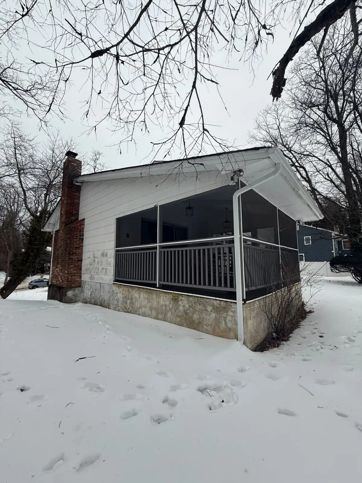 Screened porch on the side of a house in winter snow, Northport, NY